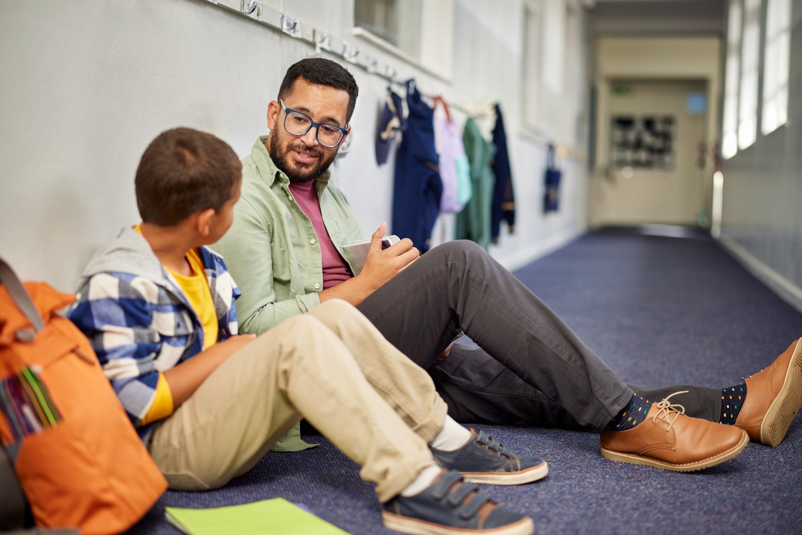 Teacher talking to young student